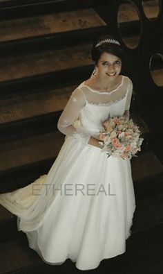 a woman in a wedding dress standing on some stairs