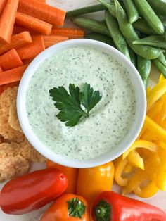 a white plate topped with vegetables and dip