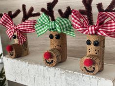 three wine corks decorated with reindeer noses and bows