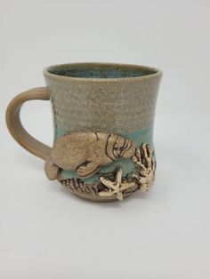 a ceramic mug with sea creatures on the outside and inside, sitting on a white surface