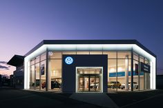 a volkswagen dealership lit up at night