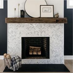 a white fireplace with black and gray walls