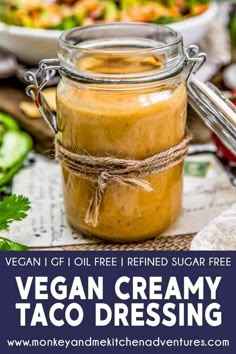 vegan creamy taco dressing in a mason jar on a table with vegetables