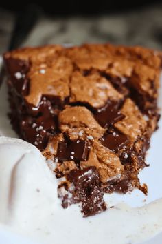 a piece of chocolate cake on a plate with ice cream