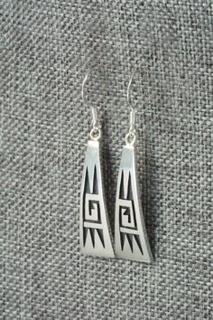 These sterling silver earrings were made by Hopi silversmith Augustine Mowa. The back is stamped sterling.Length: 1 1/2"Width: 3/8"Free shipping on all orders! We ship with USPS and always include tracking. All orders ship within a day of payment.Returns are accepted up to 30 days after you receive your order. Just send us a message. Our shop offers cash back or store credit. The item must be returned in new condition. Classic Engraved Sterling Silver Earrings, Silver Engraved Symbolic Earrings, Silver Symbolic Engraved Earrings, Engraved Sterling Silver Dangle Earrings, Symbolic Engraved Silver Earrings, Symbolic Hallmarked Sterling Silver Earrings, Traditional Sterling Silver Engraved Earrings, Traditional Engraved Sterling Silver Earrings, Hopi Jewelry