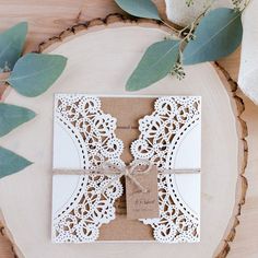 the wedding stationery was made from paper and lace, with a ribbon tied around it