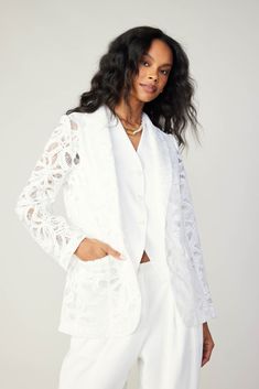 This white lace blazer features delicately sheer construction, offering a glimpse of what's underneath. It's cut for a smart, single-breasted silhouette and accented by slightly puffed shoulders. Notched lapels, tonal buttons, and flap pockets are classic tailored details, but the look is fresh and feminine. Pair it with our matching lace shorts for coordinated statement. •Notched lapels •Button closures •Flap pockets •Long sleeves •Vented back hem •Classic fit •Unlined, sheer lace Item number 2 Elegant Outerwear With Lace Trim For Work, Elegant Workwear Outerwear With Lace Trim, Elegant White Lace Outerwear, Formal Lace Outerwear With Lace Trim, Fall Wedding Lace Outerwear, Long Sleeve Lace Blazer For Spring, Elegant Lace Trim Outerwear For Spring, Elegant Spring Outerwear With Lace Trim, Elegant Lace Outerwear With Lace Trim