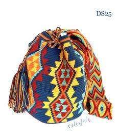 Colorful & unique crochet bag in Boho Chic style, featuring a beautiful color combination of Yellow, Turquoise, Burgundy (Dark Red), Navy Blue, and Orange. Perfect colors for Fall or Summer! Very lightweight, durable and comfortable to carry on. Wear it as a cross-body or shoulder bag. This stunning bohemian bag is perfect for a casual day, as a beach/pool accessory or as a complement to your sports outfit. Details: Bucket Style Crochet Bag Traditional indigenous symbology pattern. Matching Multicolor Traditional Crochet Bag For Vacation, Colorful Bohemian Crochet Beach Bag, Blue Bohemian Crochet Woven Bag, Blue Bohemian Crochet Bag With Woven Details, Bohemian Hand-knitted Blue Bags, Boho Style Bag, Sports Outfit, Bohemian Bag, Crochet Boho Bag