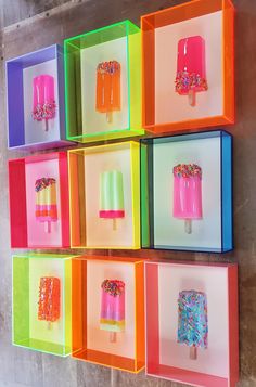 colorful ice creams and popsicles are displayed on the wall