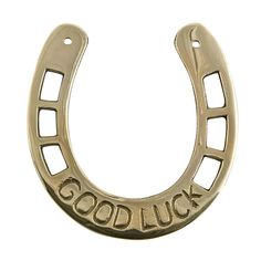 a gold horseshoe with the word good luck on it's side and an inscription that says