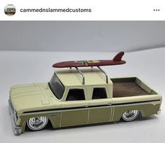 a toy truck with a surfboard on top