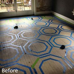 an empty room with blue and green paint on the floor