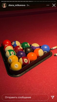 a pool table with several billiards and eight ball balls on it, ready to be played