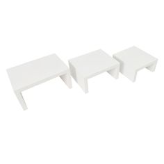 three white tables sitting next to each other