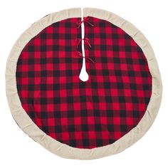 a red and black plaid round dog bed with a white cord on the end of it