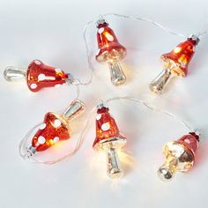 christmas lights with red and white bulbs are arranged in the shape of santa's hats