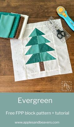 the evergreen tree block pattern is shown with scissors and fabric