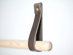 a close up of a baseball bat on a white wall with a wooden stick sticking out of it