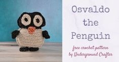 a small crocheted penguin sitting on top of a wooden table next to a sign that says osvaldo the penguin