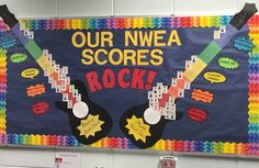 a bulletin board that says our nwea scores rock with guitars and stars on it