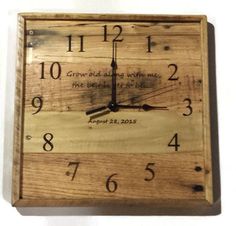 a square wooden clock with the words great big adventure on it's face and hands