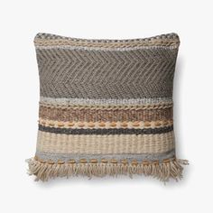 a decorative pillow with fringes on the front and sides, made from woven material