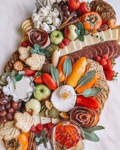 a platter filled with lots of different types of food on top of a table