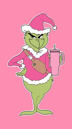 the grinch is holding a drink and wearing a santa claus hat, while standing in front of a pink background