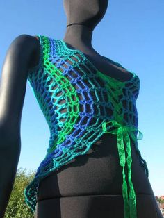 a mannequin wearing a green and blue crochet wrap around it's waist