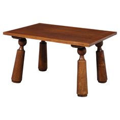 a small wooden table with two legs on each side and one leg raised up to the ground