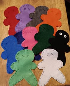 there are many different colored felt shapes on the table