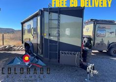 a trailer that is sitting in the gravel with an advertisement for colorado camper trailers