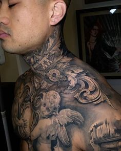 a man with tattoos on his neck and chest