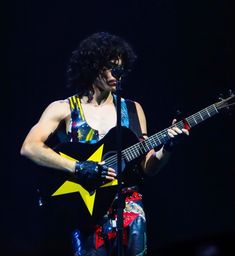 a man with an electric guitar on stage