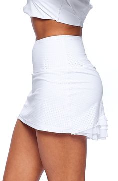 Color: Cloud White Description: The Cute As A Bunny Skirt is the perfect blend of fun and functionality with just the right amount of girlie! High-waisted and court-ready with an a-line silhouette and layers of flirty mesh at the back to finish. A comfy inner short and lightweight feel make this one a must-have for tennis season and beyond. Comfy inner short Designed & uniquely fit to flatter every size Layers of flirty mesh in back FIT True to size A-line silhouette and high waisted Model is 5’ Chic Tiered Skort With Built-in Shorts, Chic Tiered Skirt With Built-in Shorts, Chic Tennis Skirt With Built-in Shorts, Flowy Tiered Tennis Skirt With Lining, Sporty Flowy Mini Skirt Bottoms, Fitted Flared Tennis Skirt With Built-in Shorts, Fitted Tiered Skort With Built-in Shorts, Fitted Tiered Mini Skirt With Built-in Shorts, Spring Tiered Skirt With Wide Waistband