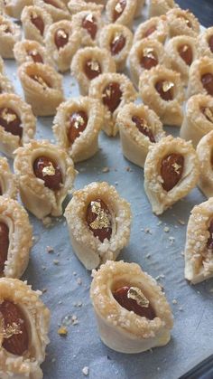 small pastries are arranged on a baking sheet and ready to be baked in the oven