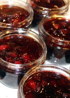 several jars filled with jam sitting on top of a table