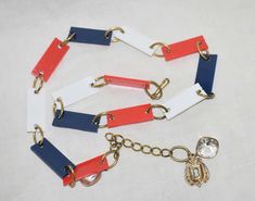 "Vintage 1970s, Patriotic Artistic Belt with Red White and Blue rectangle plastic pieces and Brass Colored Metal Round Links, Fashion Belt, Plastic Rectangle and Metal Links with decorative clear bead and key lock. The belt is in perfect condition. Belt measures .75\" wide x 33\" long without bauble & 39\" entire length. Purchased items are sold \"as-is\" with no guarantee or warranty implied. Each item listed is hand ade or vintage (formally used) unless stated otherwise. Any flaws or defects a Red Birthday, Costume Sewing Patterns, 70’s Fashion, Metal Belt, Milwaukee Wi, Couture Vintage, Sewing Items, Suspender Belt, Vintage Sewing Patterns