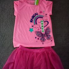 This Is A Size 3t Set. New With Tags. It Is A Fuchsia Mesh Tutu With Elastic Waistband 9'' Long,Incuding Wb. And A Neon Pink Tee Shirt With A Butterfly Screen Print And Tulip Style Sleeves. 100% Polyester. Each Piece Has $12.99 Price Tag Playful Pink Stretch Top, Pink Stretch Top For Playtime, Pink T-shirt For Spring Playwear, Pink T-shirt For Playwear In Spring, Pink Spring T-shirt For Playtime, Spring Pink T-shirt For Playwear, Pink Stretchy Top For Playwear, Pink Stretch Top For Playwear, Stretch Pink Tops For Playwear