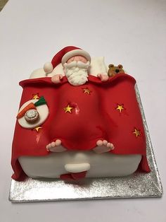 a red cake with santa claus on it