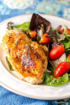 a white plate topped with chicken and salad