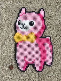 a pink pixelated animal with a yellow bow tie on it's chest sitting on the floor