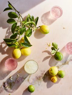 several lemons and limes on a table