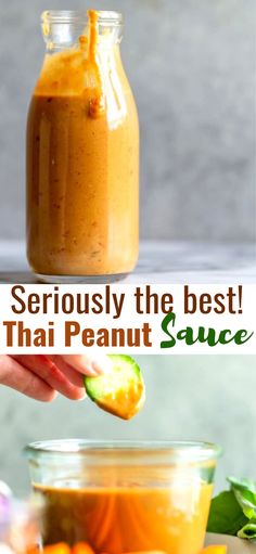 a person holding an orange slice in front of a jar filled with thai peanut sauce