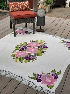 a white rug with purple flowers on it