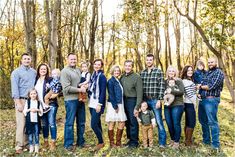 a large family posing for a photo in the woods