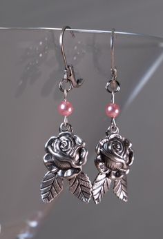 Antiqued silver Rose earrings accented with a mauve/pinkish 4mm pearls. Pink Flower Metal Earrings, Pink Flower-shaped Metal Earrings, Nickel-free Metal Pearl Drop Earrings, Pink Vintage Earrings For Anniversary, Elegant Pink Flower Earrings In Sterling Silver, Elegant Pink Sterling Silver Flower Earrings, Pink Metal Drop Flower Earrings, Pink Pierced Earrings As Gift, Pink Nickel-free Clip-on Earrings As Gift