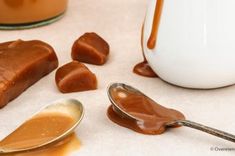 spoons and caramel sauce sitting on a table