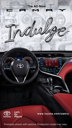 the interior of a car with red leather seats and steering wheel, in front of an advertisement for toyota