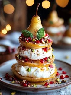 a plate topped with desserts and fruit on top of each other, surrounded by lights